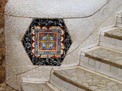 a hexagon and square feature tile above white-tiled steps 